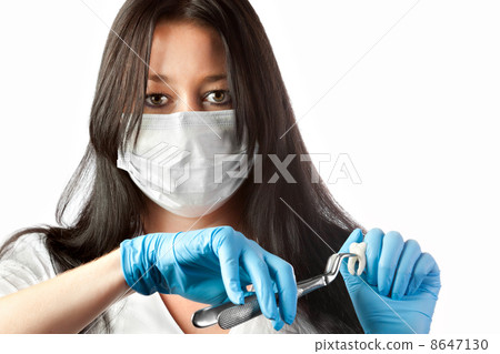 female dentist in mask holding forceps and tooth isolated female dentist in mask holding forceps and tooth isolated 8647130