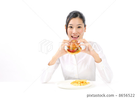 A woman eating a hamburger A woman eating a hamburger 8656522
