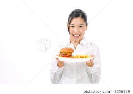 A woman eating a hamburger A woman eating a hamburger 8656529