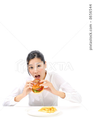 A woman eating a hamburger A woman eating a hamburger 8656544
