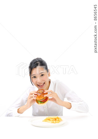 A woman eating a hamburger A woman eating a hamburger 8656545
