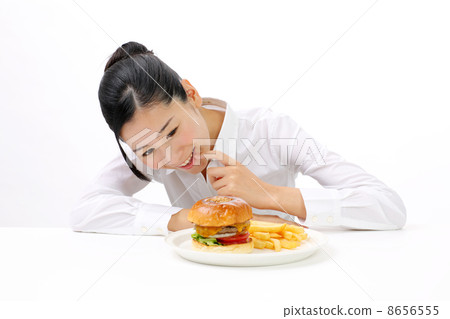 A woman watching a hamburger 8656555