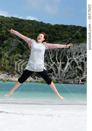 A woman nestling at Whitehaven Beach A woman nestling at Whitehaven Beach 8657605