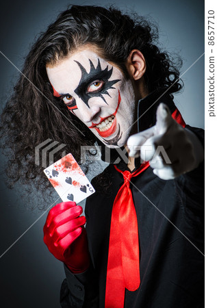 Evil clown with cards in dark room Evil clown with cards in dark room 8657710