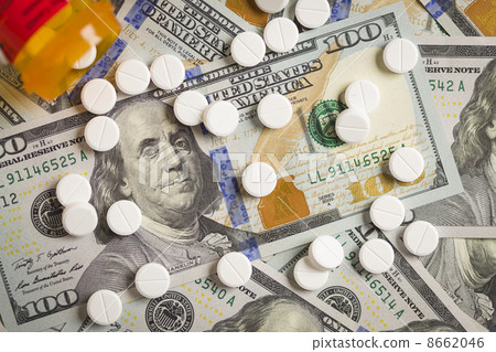 Medicine Pills Scattered on Newly Designed One Hundred Dollar Bi Medicine Pills Scattered on Newly Designed One Hundred Dollar Bi 8662046