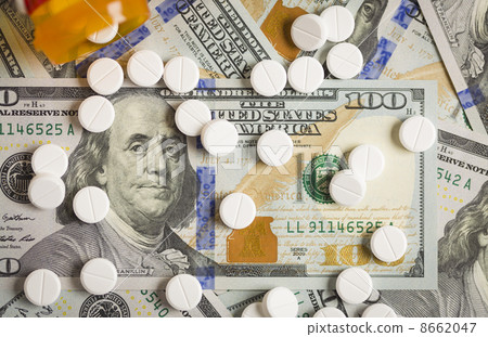 Medicine Pills Scattered on Newly Designed One Hundred Dollar Bi Medicine Pills Scattered on Newly Designed One Hundred Dollar Bi 8662047