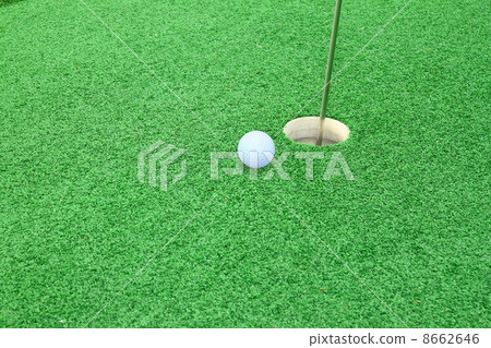 golf ball on lip of cup 8662646