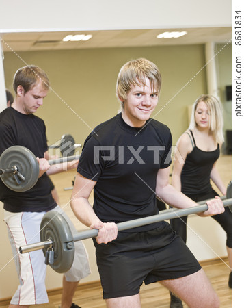 Group of people lifting weights 8681834