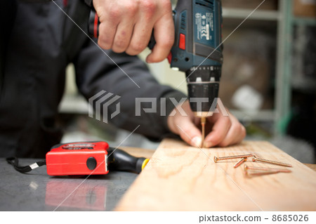 Man with screwdriver. Focused on screw in front Man with screwdriver. Focused on screw in front 8685026