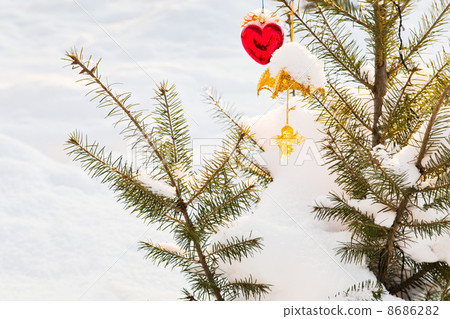 Christmas-tree decorations on tree under snow outdoor Christmas-tree decorations on tree under snow outdoor 8686282