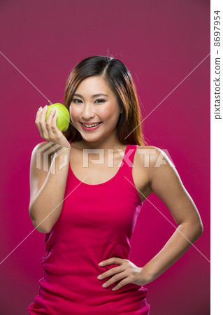 Happy Chinese Woman holding an apple on pink background. Happy Chinese Woman holding an apple on pink background. 8697954