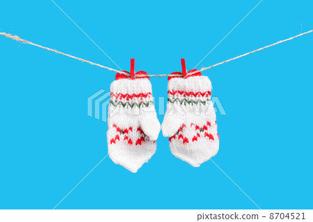 Two mittens isolated on blue background Two mittens isolated on blue background 8704521