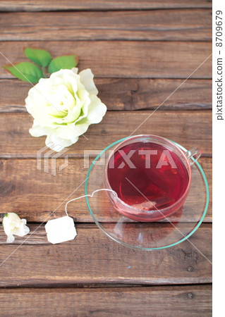 Rosehip tea brewed with teabags and white roses Rosehip tea brewed with teabags and white roses 8709679