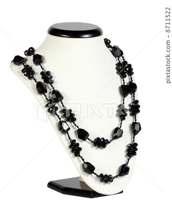 Costume bijouterie on a stand on the white background Costume bijouterie on a stand on the white background 8711522