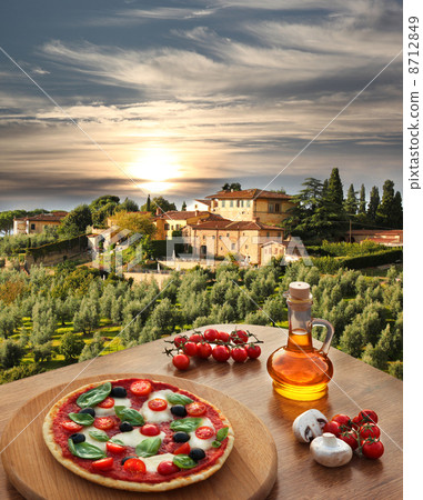 Italian pizza in Chianti against olive trees and villa in Tuscany, Italy Italian pizza in Chianti against olive trees and villa in Tuscany, Italy 8712849
