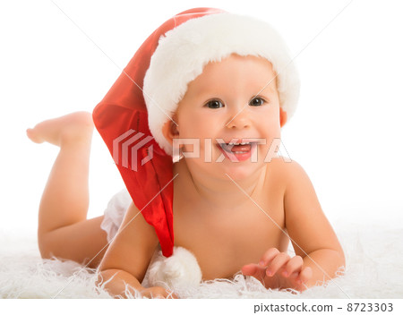 Beautiful funny baby in a Christmas hat isolated on white Beautiful funny baby in a Christmas hat isolated on white 8723303