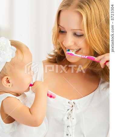 mother and daughter baby girl brushing their teeth together mother and daughter baby girl brushing their teeth together 8723304