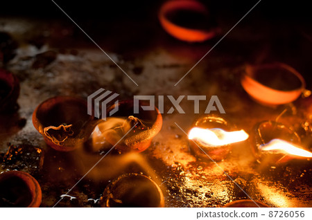 Burning oil lamps at religious temple 8726056