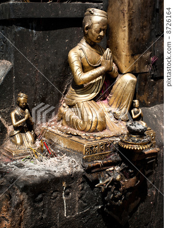 Golden sculpture of praying man. Nepal 8726164