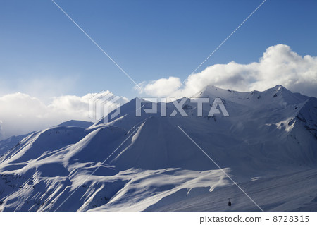 View on ski slope and sunlight mountains in evening View on ski slope and sunlight mountains in evening 8728315