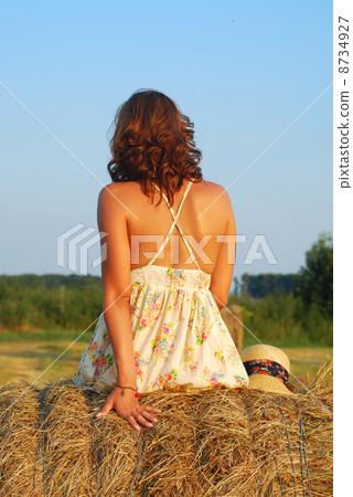 Brunette girl on fresh straw Brunette girl on fresh straw 8734927