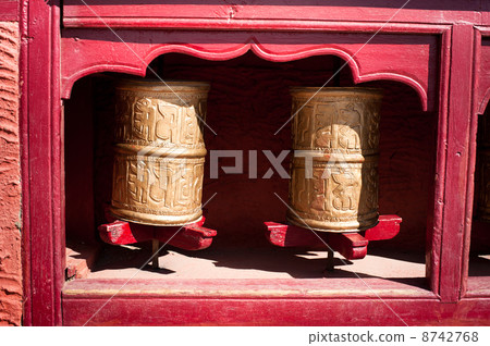 Buddhist prayer wheels in Tibetan monastery. India, Himalaya, La 8742768