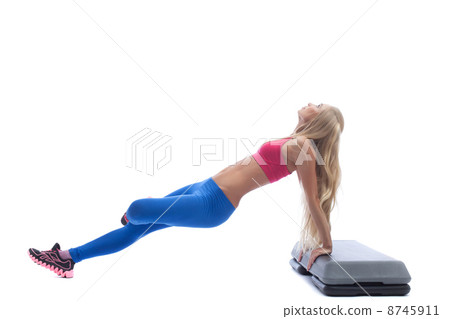 Beautiful slim blonde doing aerobics exercises Beautiful slim blonde doing aerobics exercises 8745911