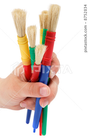 Female hand holding colorful brushes for drawing, isolated over 8752834