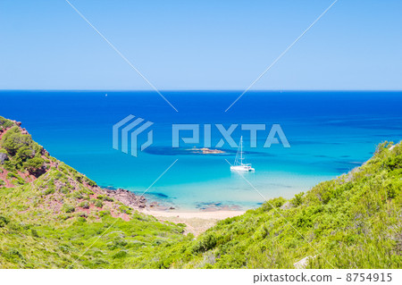 Cala del Pilar beach scenery in sunny day at Menorca, Spain. 8754915
