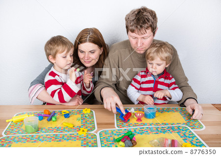 Happy family of a four having fun at home 8776350