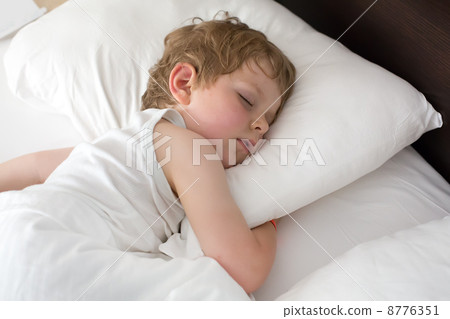 Little sweet toddler boy sleeping in his bed 8776351