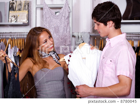 Attractive young couple in clothes department Attractive young couple in clothes department 8780045