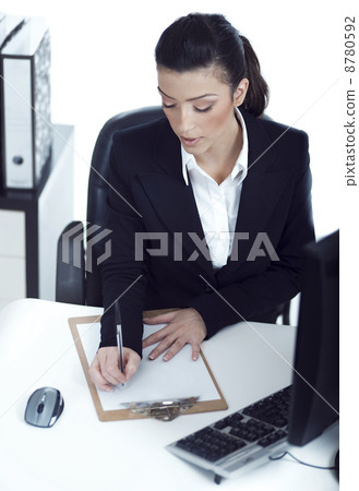 Busy business lady making her notes on the clipboard Busy business lady making her notes on the clipboard 8780592