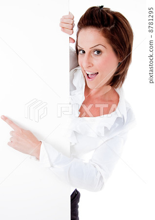 Happy young female holding a blank billboard, pointing at it 8781295