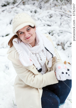 Young woman having fun with snow on winter day 8782847