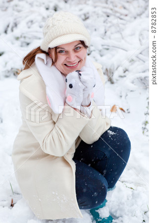 Young woman having fun with snow on winter day 8782853