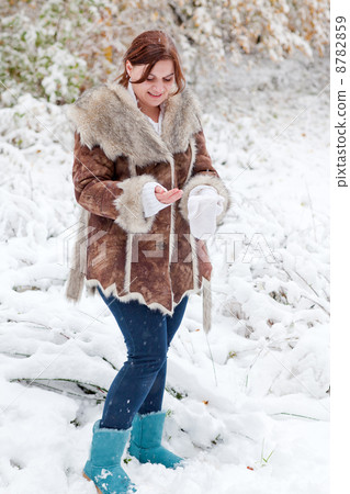 Young woman having fun with snow on winter day 8782859