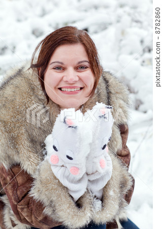 Young woman having fun with snow on winter day 8782860