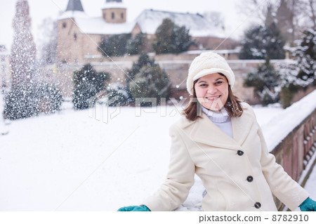 Young woman having fun with snow on winter day 8782910