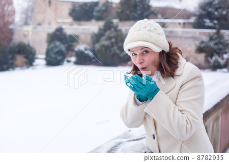 Young woman having fun with snow on winter day 8782935