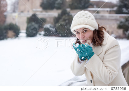 Young woman having fun with snow on winter day 8782936