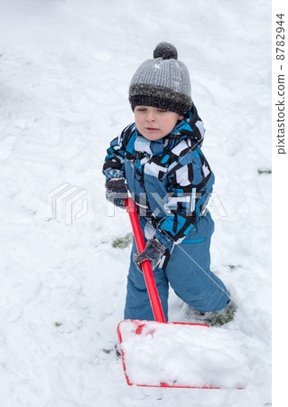 Adorable toddler boy happy about snow in winter 8782944