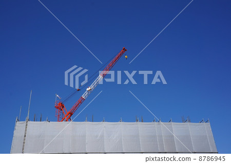 A crane extending into the blue sky 8786945