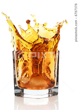 Glass with splashing whisky drink Glass with splashing whisky drink 8787378