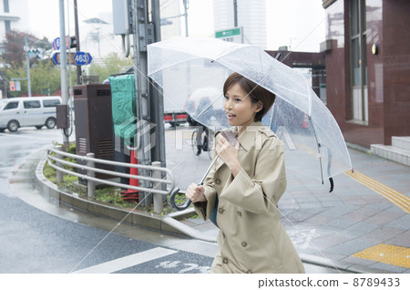 A woman running through an umbrella A woman running through an umbrella 8789433