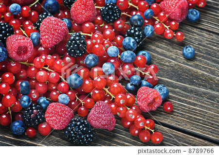 blackberries, currants, raspberries, blueberries on a wooden tab 8789766