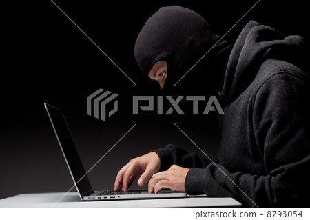 Computer hacker in a balaclava Computer hacker in a balaclava 8793054
