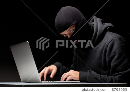 Computer hacker in a balaclava 8793063