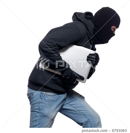 Thief stealing a laptop computer 8793065