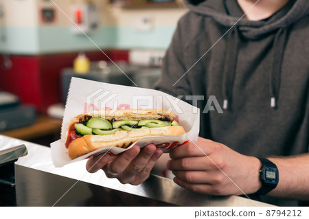 salesman with hotdog in fast food snack bar 8794212
